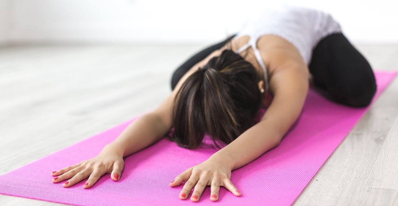 Woman doing yoga pose on a mat